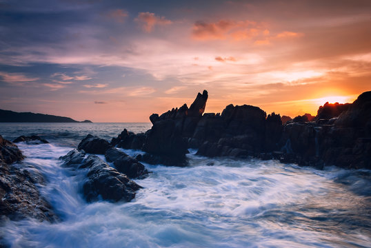 Seascape of wave on rock , Long Exposure at Sunset on the beach in Phuket Thailand. © yingtanthawarak