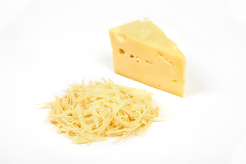 piece of cheese and heap of grated cheese, isolated on white background.