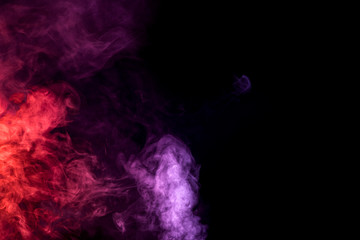 Colorful  pink and red  smoke clouds on dark background.Background of smoke vape