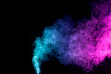 Thick colorful smoke of  purle and pink on a black isolated background. Background from the smoke of vape