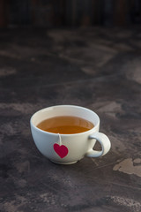 Cup of tea with heart shaped teabag tag