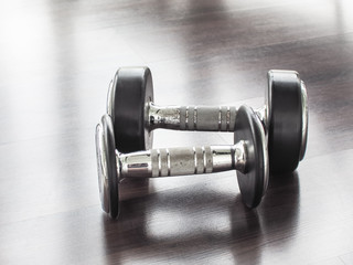 Two dumbbell in at the gym room /Color filter/ With place your text