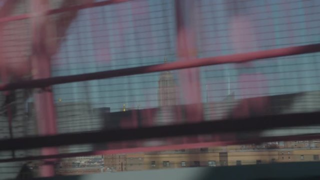 shot from the JMZ train riding the Williamsburg bridge overlooking at Manhattan and the Empire State building.