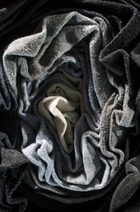 Socks of light and dark fabric. Abstract form of folded underwear.