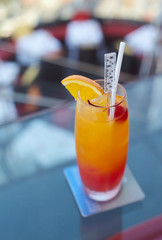 Fruits cocktail in the long glass on the glasses table