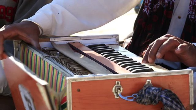 Close up shot of traditional musical instruments harmonium playing in Jaisalmer fort, Rajasthan, India