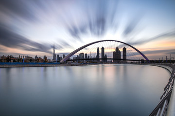 Long exposure of stunning sunrise colors over Dubai Downtown and Dubai Water Canal. Dubai, UAE.