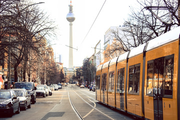 Yellow  public transportation tram passing by the city of Berlin Germany  - obrazy, fototapety, plakaty