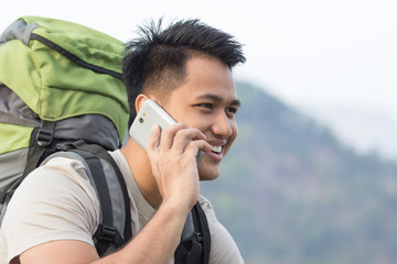 male hiker using mobile phone