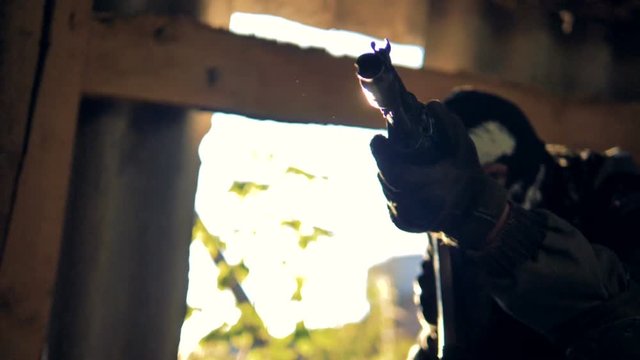A rotating view on a military man with a pointed rifle. 