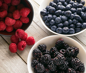 Bowls of fresh fruit; blueberry, raspberry, blackberry 