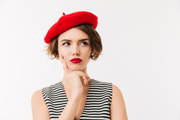 Portrait of a pensive woman dressed in red beret - obrazy, fototapety, plakaty