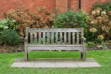 wooden bench on green grass in a park