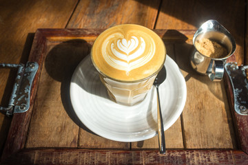 coffee cup with morning sunlight on wood table background