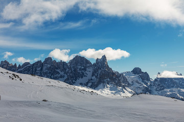 Dolomites, ski area with beautiful slopes. Empty ski slope in winter on a sunny day. Prepare ski slope, Alpe di Lusia, Italy