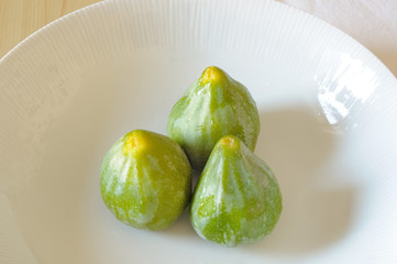 organic fresh green figs in white dish
