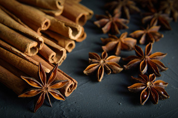  shelves of cinnamon and anise stars in dark colors on a dark concrete stone background