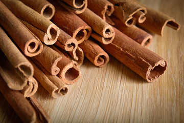shelves of cinnamon in dark colors on a wooden background