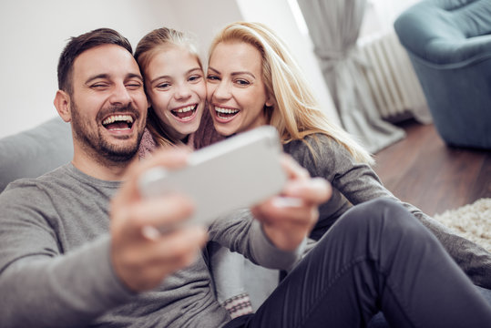 Happy Family Taking Selfie At Home