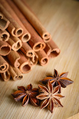  shelves of cinnamon and anise stars in dark backgrounds on a wooden background