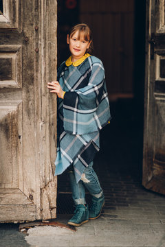 Fashion Portrait Of Pretty Little Girl Wearing Blue Plaid Poncho