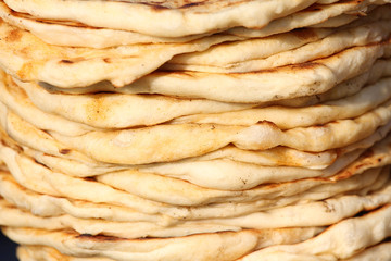Pita. Pile of roasted pita, baked flat bread. Heap of focaccia bread. Lavash. Purlenka