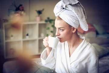 Morning coffee at bed. Middle age woman.