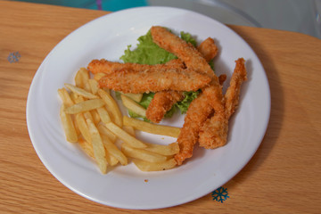 Chicken nectar with potato free . Chicken steak and potatoes on a wooden background. Top view. Free space for text.