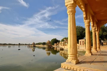 Foto op Plexiglas View of chhatris (through arches and columns) at Gadi Sagar lake, Jaisalmer, Rajasthan, India © Christophe Cappelli
