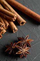  shelves of cinnamon in dark colors on a dark concrete stone background