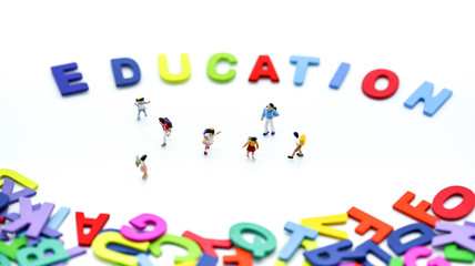 Miniature people : children and student with colorful wooden English alphabe,education concept.