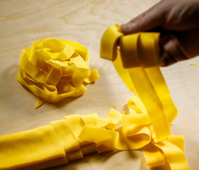 Pappardelle.Traditional italian homemade fresh pasta, after cut. © GiorgioMorara