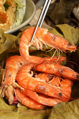 A pile of steamed shrimps on lotus leaf