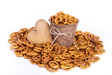 Salty pretzels in paper cup. Snack to beer. Bretzel in paper bucket.