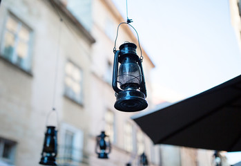 Vintage black kerosene oil lantern lamps. Terrace decor. Shallow focus.