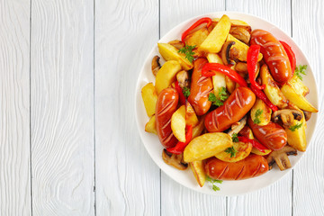 sausages with fried vegetables on plate
