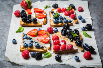 Selection of toasts with cheese peanut butter and berries