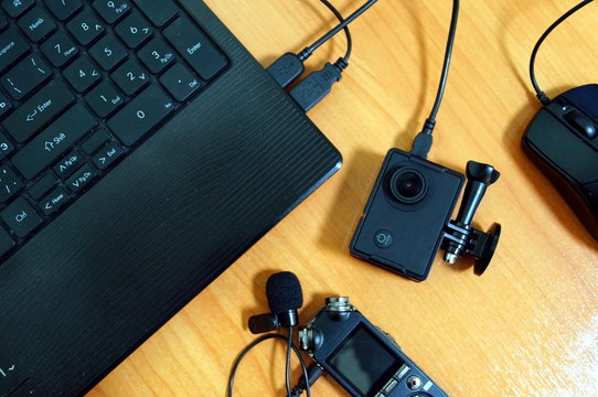 Video blogger desktop with laptop action camera and audio recorder