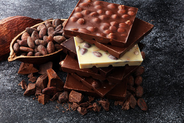 Chocolate bars on dark background with chocolate tower
