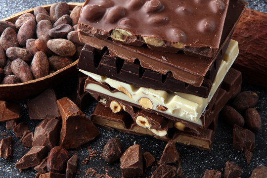 Chocolate bars on dark background with chocolate tower
