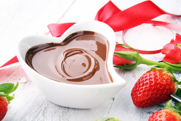 Valentine Chocolate fondue melted with fresh strawberries and dark chocolate and roses