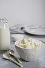 Organic Farming Cottage cheese, curd in a white ceramic  bowl, sour cream and milk in a bottle