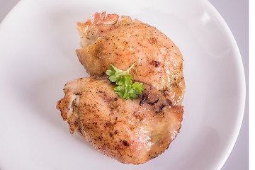 roasted chicken tights on white plate 