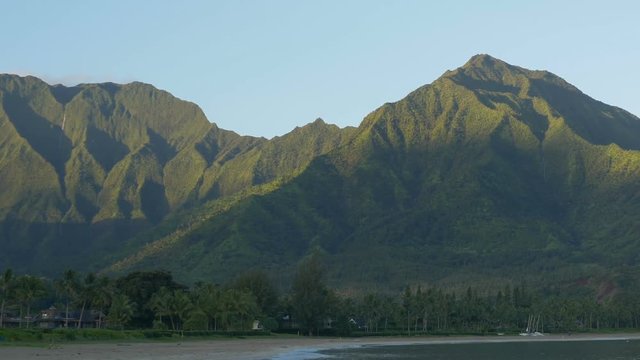 Zooming out view of mountains surrounding Hanalei Bay, Kauaii, Hawaii, shortly after sunrise.