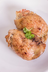 roasted chicken tights on white plate 
