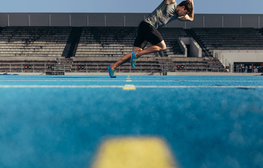 Sprinter taking off for a run from the start line