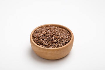 close up of flax seeds on white background. Healthy food concept for preventing heart diseases and overweight.