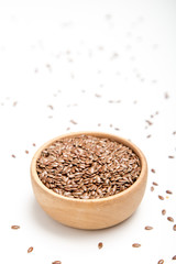 close up of flax seeds on white background. Healthy food concept for preventing heart diseases and overweight.