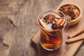hot spicy beverage. Hot drink (apple tea, punch) with cinnamon stick and star anise. Seasonal mulled drink
