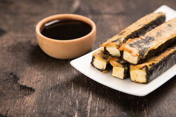 Tofu fried in nori. Served with sauce. Japanese Cuisine. Asian food concept.